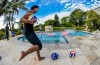 Ronaldinho pinging footballs at guys running across a swimming pool