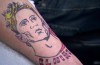 After losing a bet Craig Burley gets Fernando Torres’ face tattooed on his arm