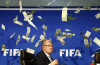 Money shot: Sepp Blatter showered with money during press conference